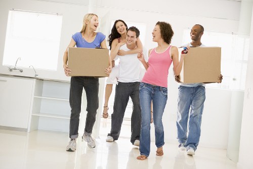 Professional furniture movers handling a sofa